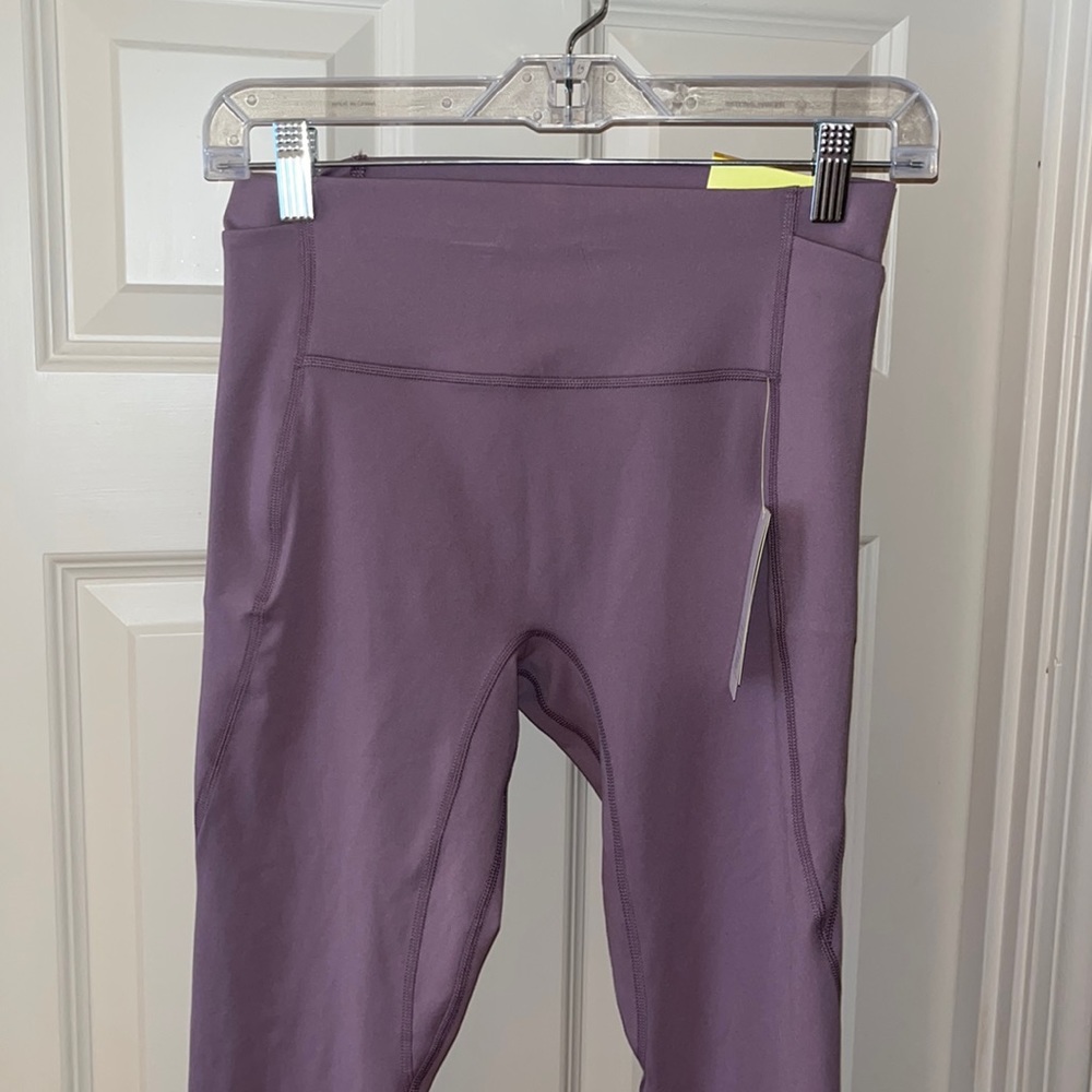All in morion lt. purple leggings with side pockets. Size S